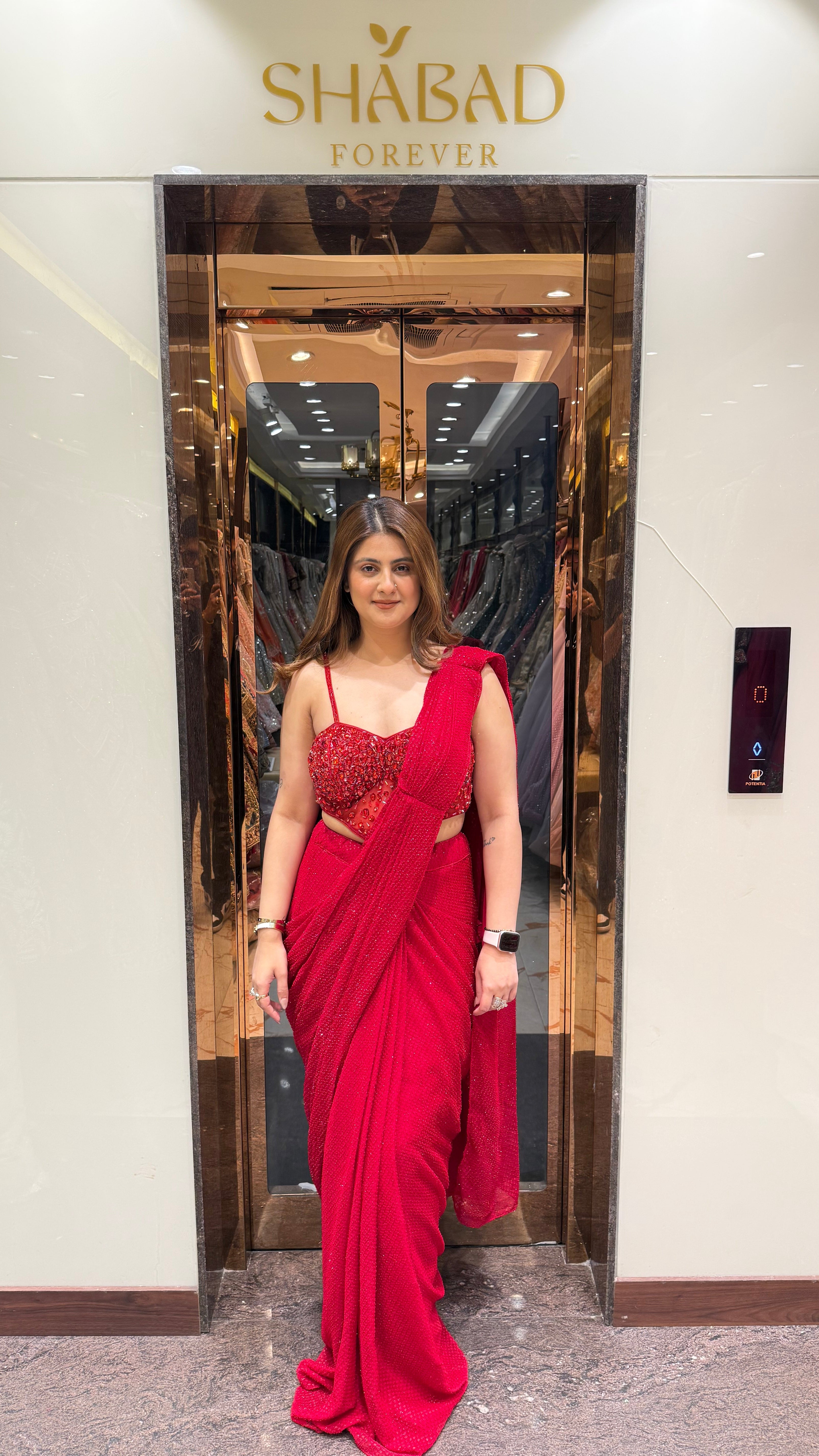 Red stone work corset blouse sequin drape saree