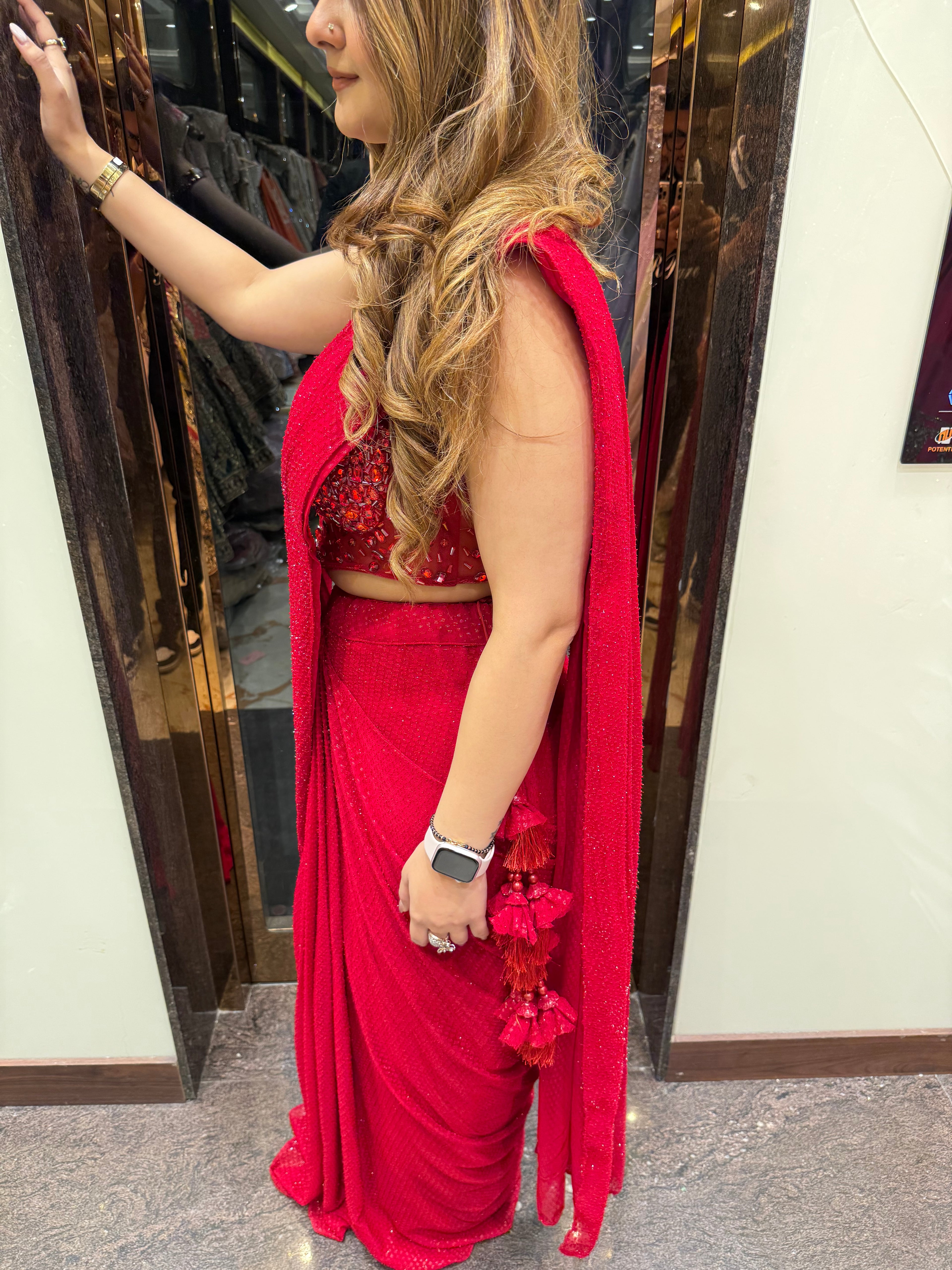 Red stone work corset blouse sequin drape saree