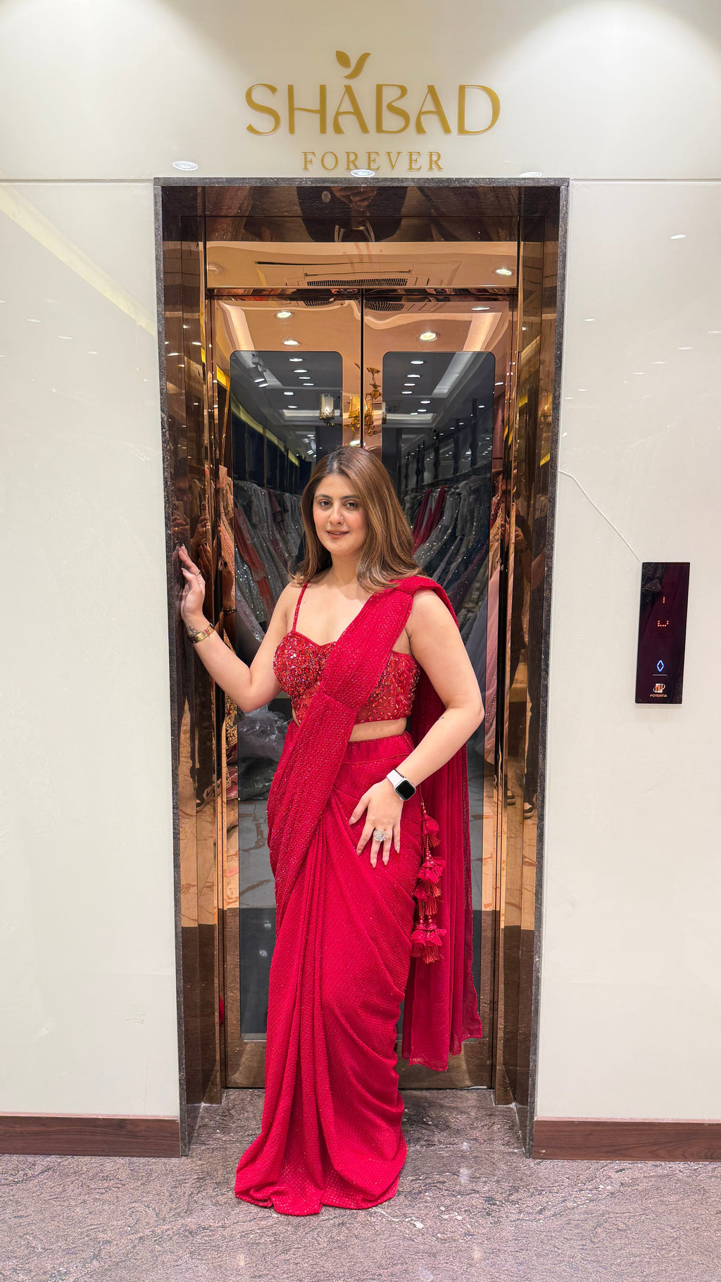 Red stone work corset blouse sequin drape saree